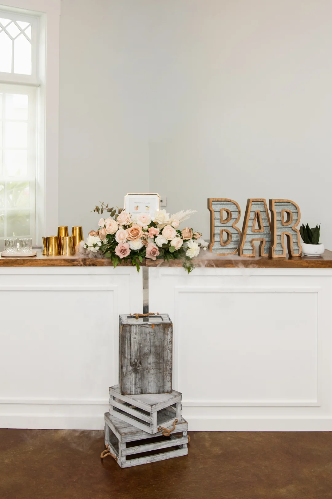 The WinterBrooke bar built and styled inside Heller Hall, with florals and gold tins on the counter
